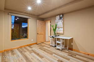 Office area with light wood-style floors and baseboards