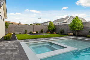 View of swimming pool with a patio, a residential view, a fenced backyard, and a pool with connected hot tub
