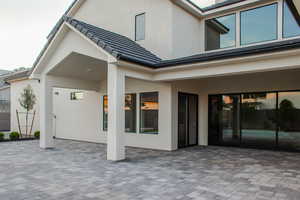 Rear view of house with a patio and stucco siding