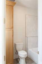 Bathroom featuring  shower combination and tile patterned floors