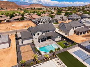 Aerial view of residential area featuring a pool area and mountains