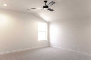 Unfurnished room featuring lofted ceiling, light carpet, a ceiling fan, and recessed lighting