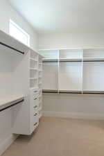 Walk in closet featuring light carpet