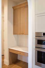 Unfurnished office with wood finished floors and baseboards