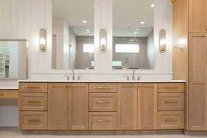 Bathroom with double vanity, walk in shower, and recessed lighting