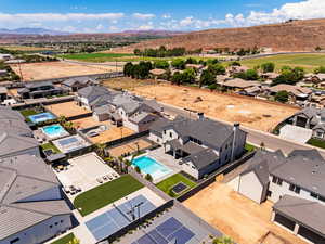 Aerial perspective of suburban area featuring a pool area and mountains