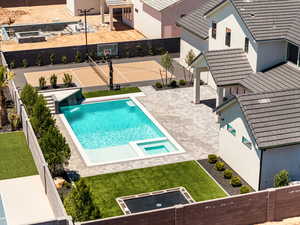 View of swimming pool with a fenced backyard, a patio, and a pool with connected hot tub