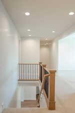 Staircase featuring recessed lighting and wood finished floors