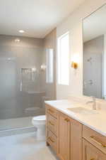 Full bath featuring vanity, a shower stall, light tile patterned floors, and recessed lighting