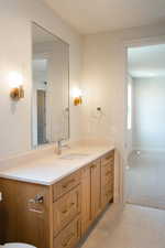 Bathroom featuring vanity, light carpet, and light tile patterned floors