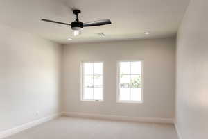 Empty room featuring light colored carpet, recessed lighting, and a ceiling fan