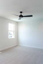 Unfurnished room with light carpet and ceiling fan