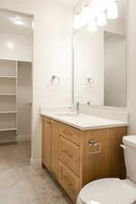 Half bathroom featuring vanity and light tile patterned floors