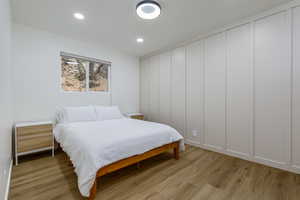 Bedroom with light wood-type flooring and recessed lighting