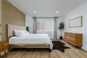 Bedroom with light wood-style floors and recessed lighting