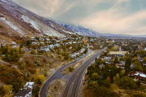 Aerial view of property's location featuring nearby suburban area and a mountain backdrop