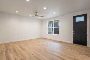 Foyer entrance with recessed lighting, light wood-type flooring, and ceiling fan