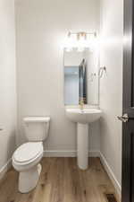 Bathroom with light wood-style flooring and baseboards