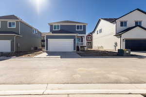 Traditional-style home featuring concrete driveway