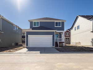 Traditional-style home featuring concrete driveway