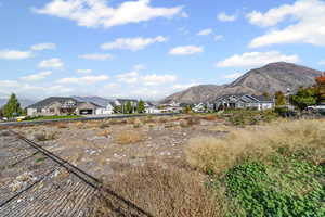 View of mountain backdrop featuring nearby suburban area