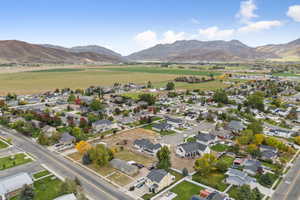 Aerial view of property's location featuring nearby suburban area and a mountain backdrop