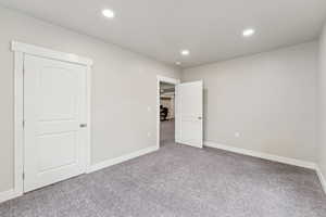 Unfurnished bedroom featuring carpet floors and recessed lighting
