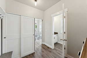 Entrance foyer featuring dark wood-style flooring and baseboards