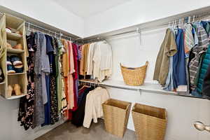 Spacious closet with carpet floors