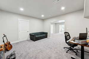 Office area featuring light carpet and recessed lighting