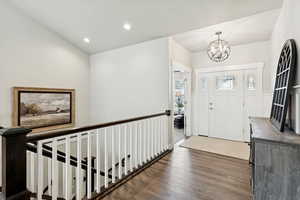 Foyer with dark wood-style floors, recessed lighting, and a chandelier