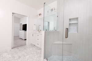 Bathroom with vanity, a stall shower, and light colored carpet