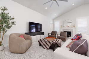 Living room featuring recessed lighting, a ceiling fan, a fireplace, and high vaulted ceiling