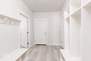 Mudroom featuring light wood-type flooring and baseboards