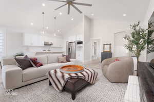 Living area with high vaulted ceiling, a ceiling fan, light wood finished floors, and recessed lighting