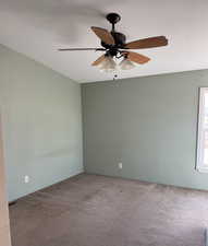 Unfurnished room with carpet and ceiling fan