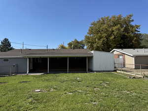 Rear view of property featuring a patio area and roof with shingles