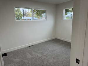 Carpeted spare room with baseboards