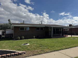 Ranch-style house with brick siding, an outdoor fire pit, and a deck