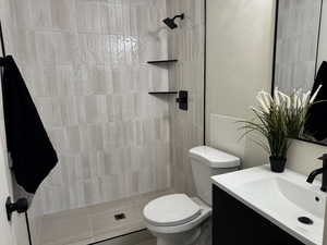 Bathroom featuring vanity and a tile shower