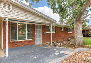 View of exterior entry featuring brick siding