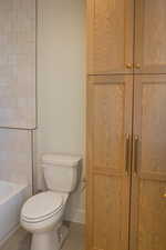 Bathroom with tile patterned floors and washtub / shower combination