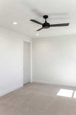 Spare room with recessed lighting, light colored carpet, and a ceiling fan