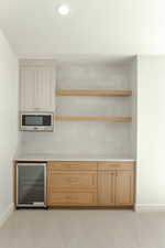 Bar area featuring open shelves, wine cooler, decorative backsplash, recessed lighting, and light carpet