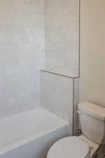 Bathroom featuring toilet and bathtub / shower combination