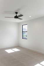 Carpeted spare room featuring recessed lighting and a ceiling fan