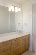 Bathroom featuring light tile patterned flooring and vanity