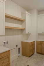 Laundry area featuring cabinet space, washer hookup, and hookup for an electric dryer