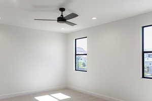 Empty room with light colored carpet, recessed lighting, and ceiling fan