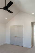 Unfurnished bedroom with recessed lighting, carpet floors, vaulted ceiling, and ceiling fan